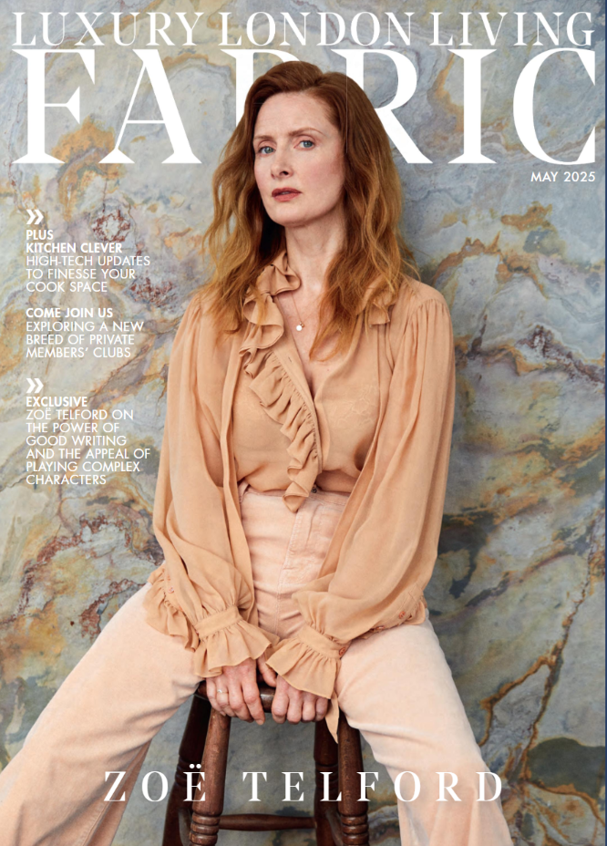 Magazine cover featuring a woman in a beige outfit with a textured wall background
